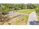 An aerial view of a well-maintained park complete with benches and flagpoles adds charm to the community at 5370 Boxtree Ct, Dade City, FL 33523