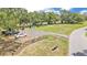 An aerial view of a well-maintained park complete with benches and flagpoles adds charm to the community at 5370 Boxtree Ct, Dade City, FL 33523