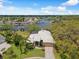 Aerial view of the property with a spacious lot, lush landscaping, and stunning waterfront access at 5903 Cachette De Riviera Ct, New Port Richey, FL 34655