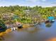 Waterfront home with a dock, boat lift, and inviting pool, perfect for enjoying the outdoors at 5903 Cachette De Riviera Ct, New Port Richey, FL 34655