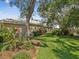 Beautiful backyard with manicured lawn and lush landscaping in a peaceful setting at 5903 Cachette De Riviera Ct, New Port Richey, FL 34655