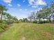 Huge backyard with lots of green grass and gorgeous trees and landscaping, plenty of space to roam at 5903 Cachette De Riviera Ct, New Port Richey, FL 34655