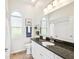 Bathroom featuring a dark granite countertop, arched windows and decorative accents at 5903 Cachette De Riviera Ct, New Port Richey, FL 34655
