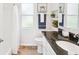 Bright bathroom featuring a dark granite countertop, decorative plants, and natural light at 5903 Cachette De Riviera Ct, New Port Richey, FL 34655