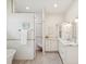 Large bathroom with marble countertops, a tub, a walk-in shower, and ample storage space at 5903 Cachette De Riviera Ct, New Port Richey, FL 34655