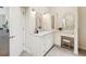 Bright bathroom vanity with white marble countertops, dual sinks and decorative mirrors at 5903 Cachette De Riviera Ct, New Port Richey, FL 34655