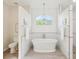 Bright bathroom featuring a soaking tub with a pendant light, a separate toilet, and a shower area at 5903 Cachette De Riviera Ct, New Port Richey, FL 34655