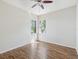 Well-lit bedroom with wood floors and a view to the outside at 5903 Cachette De Riviera Ct, New Port Richey, FL 34655