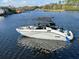 A white Yamaha boat on a river with a black canopy and blue bumpers is ready for a day of fun on the water at 5903 Cachette De Riviera Ct, New Port Richey, FL 34655