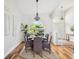 Inviting dining room boasts hardwood floors, natural light, and a modern chandelier at 5903 Cachette De Riviera Ct, New Port Richey, FL 34655