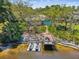 Waterfront backyard featuring a private dock, seating area, and jet skis, ideal for water activities at 5903 Cachette De Riviera Ct, New Port Richey, FL 34655