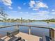 View of a waterfront dock with chairs in a gorgeous waterway setting perfect for relaxation and entertainment at 5903 Cachette De Riviera Ct, New Port Richey, FL 34655