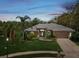 Charming single-story home featuring lush landscaping and a well-manicured lawn at 5903 Cachette De Riviera Ct, New Port Richey, FL 34655