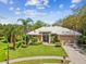Beautifully landscaped home featuring a well-maintained lawn, mature trees, and a welcoming entrance at 5903 Cachette De Riviera Ct, New Port Richey, FL 34655