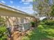 Home exterior showing the generator with a lush garden bed next to the home at 5903 Cachette De Riviera Ct, New Port Richey, FL 34655