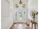 Bright foyer boasts natural light, elegant tile flooring, and a modern chandelier at 5903 Cachette De Riviera Ct, New Port Richey, FL 34655