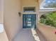Inviting front entrance with a stylish blue door and transom window, showcasing the home's curb appeal at 5903 Cachette De Riviera Ct, New Port Richey, FL 34655