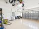 Spacious two car garage with white epoxy floor, finished walls and ceiling, and garage door opener at 5903 Cachette De Riviera Ct, New Port Richey, FL 34655