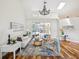 Open living room featuring high ceilings, chandelier, and access to the outdoor pool area at 5903 Cachette De Riviera Ct, New Port Richey, FL 34655
