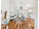 Spacious living room with skylights, hardwood floors, and sliding glass doors to patio at 5903 Cachette De Riviera Ct, New Port Richey, FL 34655