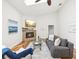 Comfortable living room showcasing a brick fireplace, skylight, and neutral decor at 5903 Cachette De Riviera Ct, New Port Richey, FL 34655