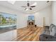 Cozy living room featuring a fireplace, skylights, and seamless access to the pool area at 5903 Cachette De Riviera Ct, New Port Richey, FL 34655