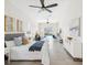 Bright bedroom featuring stylish decor, a ceiling fan, and large windows showcasing a pool view at 5903 Cachette De Riviera Ct, New Port Richey, FL 34655