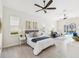 Bright bedroom with a ceiling fan, a comfortable bed and a sitting area with a view of the pool at 5903 Cachette De Riviera Ct, New Port Richey, FL 34655