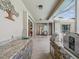 Outdoor kitchen with stone countertops, stainless steel grill, sink and easy access to indoor dining at 5903 Cachette De Riviera Ct, New Port Richey, FL 34655