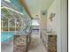 A stacked stone outdoor kitchen offers a sink, grill and countertop space for easy entertaining at 5903 Cachette De Riviera Ct, New Port Richey, FL 34655