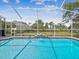 A lovely screened in pool offers clear water, a small waterfall and lush tropical backyard at 5903 Cachette De Riviera Ct, New Port Richey, FL 34655