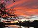 Waterfront home featuring a beautiful sunset over the water at 5903 Cachette De Riviera Ct, New Port Richey, FL 34655