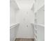 White walk-in closet with shelving and hanging rods for ample storage at 5903 Cachette De Riviera Ct, New Port Richey, FL 34655