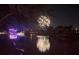 Festive waterfront scene with fireworks illuminating the sky and reflecting on the water at 5903 Cachette De Riviera Ct, New Port Richey, FL 34655