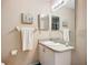 Cozy bathroom featuring a single sink vanity with granite countertop and decorative mirror and towel rack at 6012 28Th W St, Bradenton, FL 34207