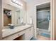 Bathroom featuring granite countertop vanity, and adjacent shower with glass doors and seating at 6012 28Th W St, Bradenton, FL 34207