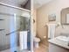 Modern bathroom featuring a glass-enclosed shower with gray tiling, a vanity, and tiled flooring at 6012 28Th W St, Bradenton, FL 34207