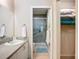 Bathroom featuring a shower with glass doors and a built in seat, plus adjacent closet access at 6012 28Th W St, Bradenton, FL 34207