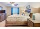 Comfortable bedroom with a floral patterned quilt, wood furnishings, and bright natural light from the window at 6012 28Th W St, Bradenton, FL 34207