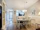 Inviting dining area featuring a wooden table set and decorative mirror, bathed in warm, natural light at 6012 28Th W St, Bradenton, FL 34207