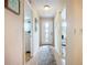 Inviting hallway with neutral tones, tile flooring, and decorative rug, connecting various rooms at 6012 28Th W St, Bradenton, FL 34207