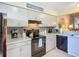 Modern kitchen featuring granite countertops, tiled backsplash, and black appliances, ready for cooking at 6012 28Th W St, Bradenton, FL 34207