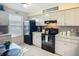 Bright kitchen with tiled backsplash, black appliances, and view of dining area; great space for gathering at 6012 28Th W St, Bradenton, FL 34207