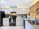 Well-equipped kitchen with modern appliances, sleek cabinets, and granite countertops, perfect for cooking at 6012 28Th W St, Bradenton, FL 34207
