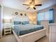 Serene bedroom featuring a plush king-size bed with teal bedding, bedside lamps, and a bright window at 6012 28Th W St, Bradenton, FL 34207