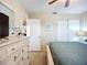 Bright bedroom with a comfortable bed, dresser, and a ceiling fan, bathed in soft natural light at 6012 28Th W St, Bradenton, FL 34207