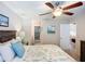 Open bedroom featuring doorway to the bathroom and adjacent living space, with ceiling fan at 6012 28Th W St, Bradenton, FL 34207