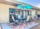 Charming patio with a dining set, umbrella, and stylish rug for outdoor enjoyment at 6012 28Th W St, Bradenton, FL 34207