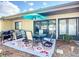 Outdoor patio featuring a dining table set with an umbrella, rug, and grill on a wooden deck at 6012 28Th W St, Bradenton, FL 34207