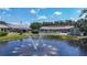 Scenic view of a community pond with a fountain and surrounding landscaping at 6012 28Th W St, Bradenton, FL 34207